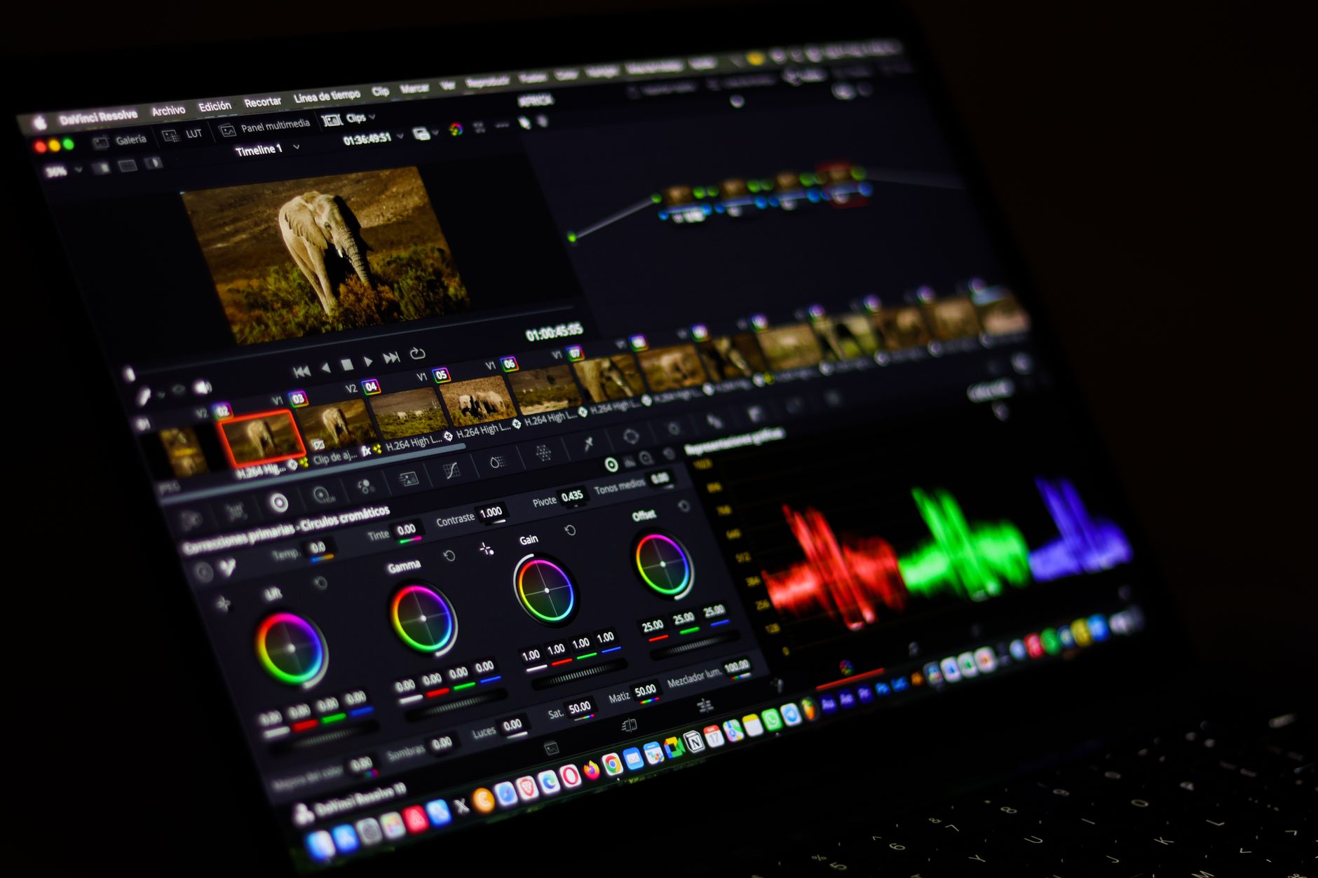 a video editor editing footage on a laptop with a timeline visible on screen