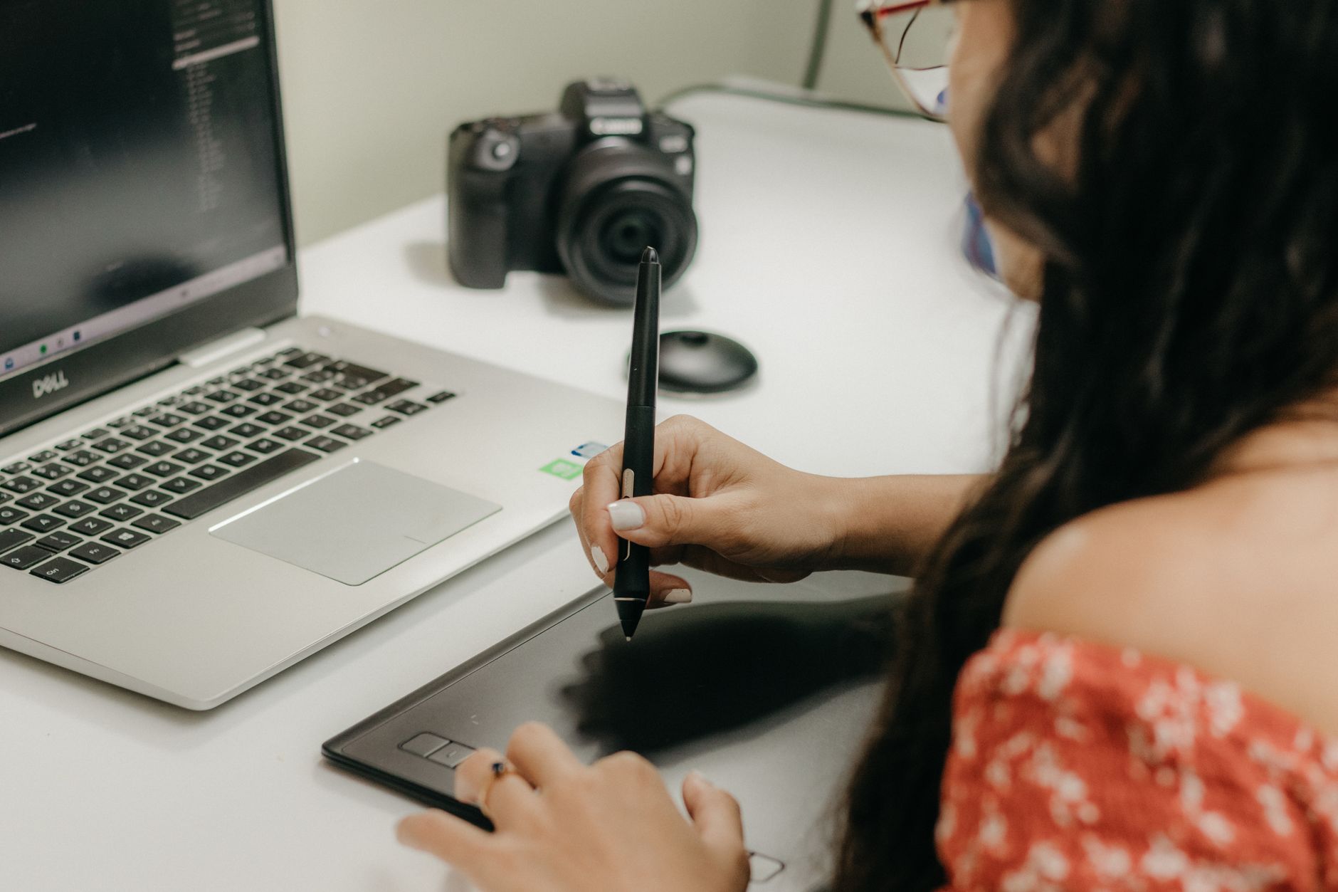 a designer creating colorful social media ad graphics on a laptop