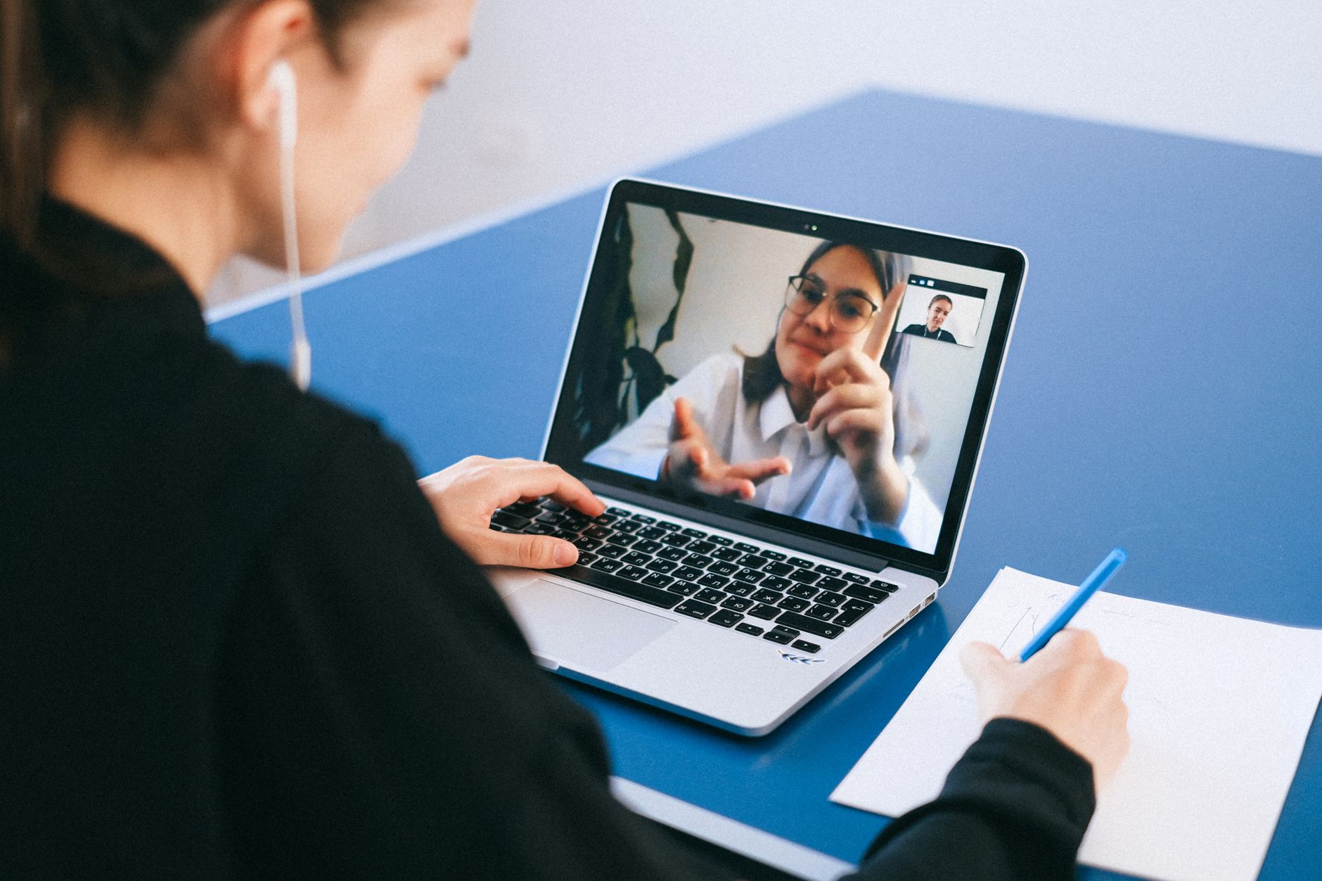 a recruiter in a video interview with candidate on screen and notes open