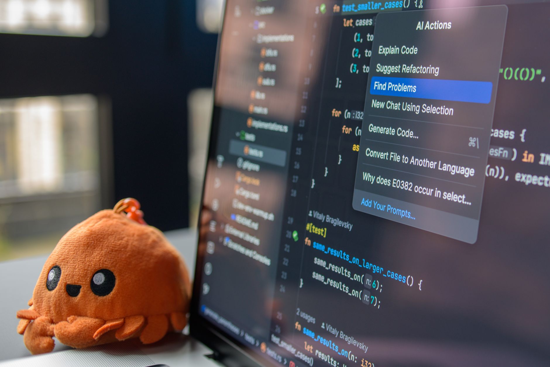 Software developer types code on laptop showing an AI suggestion popup in VS Code
