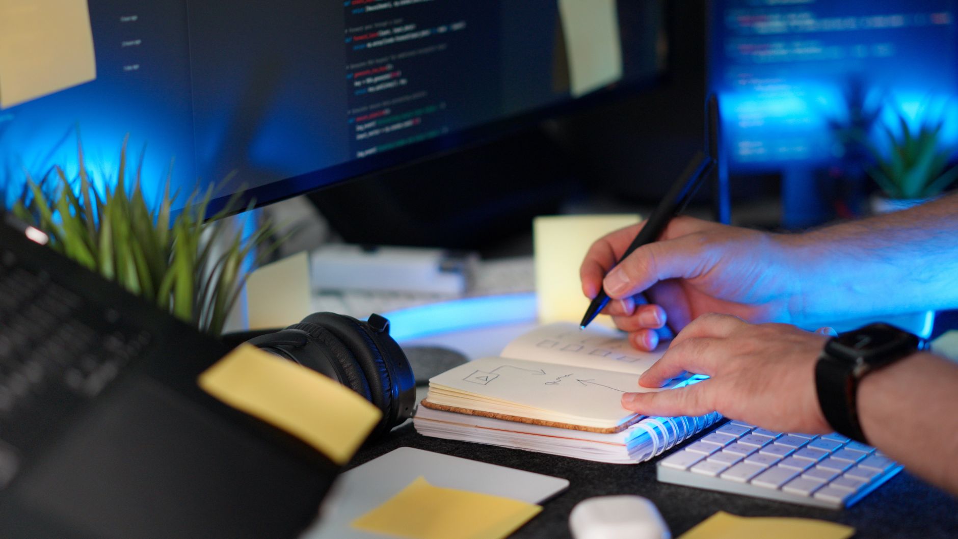 a person organizing digital research notes in a project dashboard on dual monitors